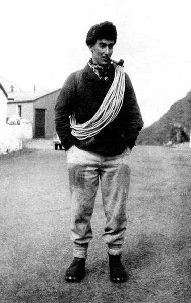 Black and White image of Jack Longland, with rope over his shoulder dressed for climbing