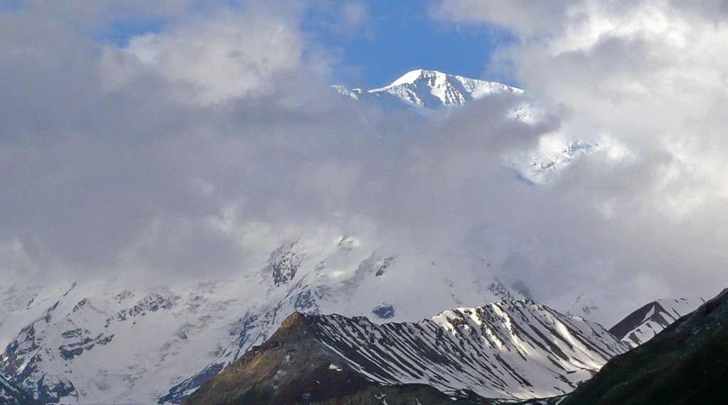 Lenin Peak emerging out of the clouds from base camp. Photo: © Richard Haszko