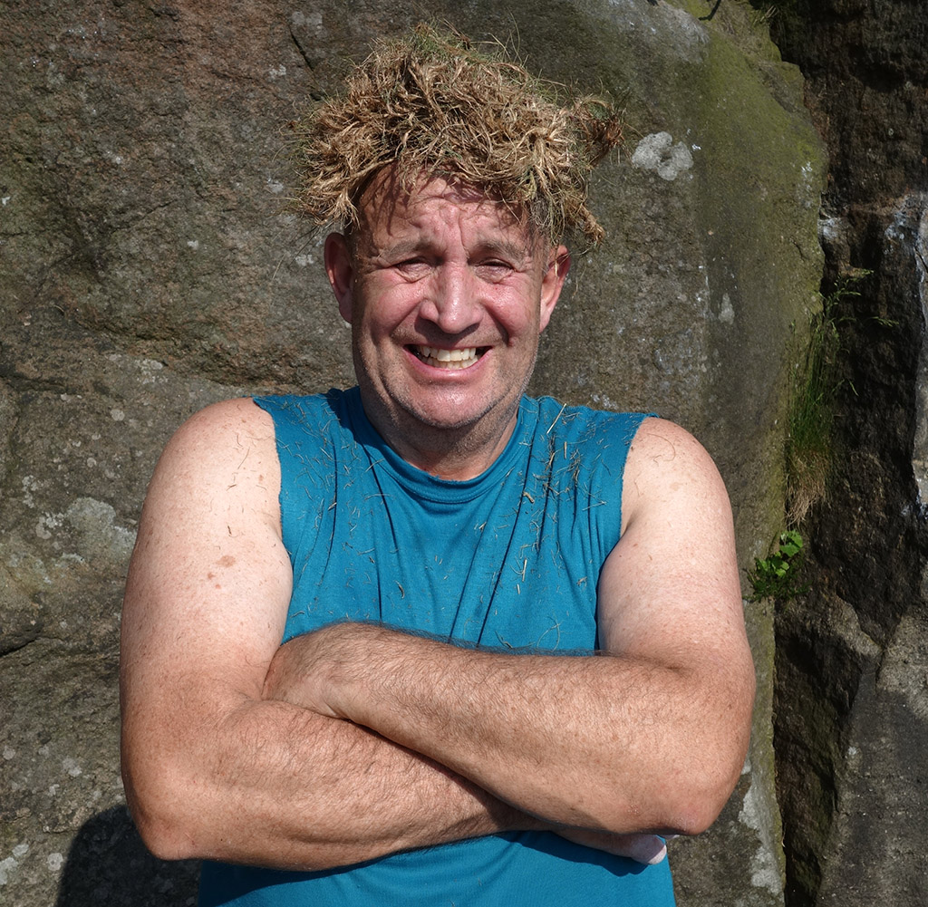 John having a laugh with his grass sod 'wig' at Curbar Edge in the Peak District. Photo: © Nick Taylor